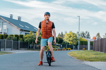 Young Man Stanging On Electric Unicycle (EUC) On Street, Best Mobile Portable Personal Transportation Vehicle, Summer Day © toyechkina