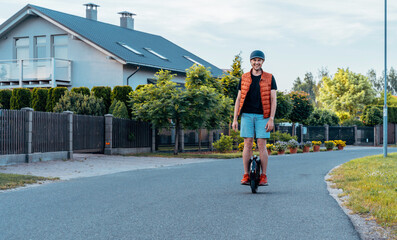 Young Man Riding On Electric Unicycle (EUC) On Street, Best Mobile Portable Personal Transportation Vehicle, Summer Day © toyechkina