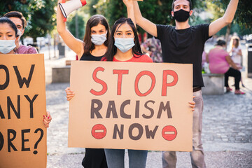 Group of young multiethnic demonstrators in a road - People protesting for equality and for stop...