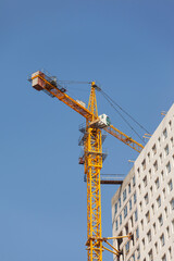 Fototapeta na wymiar Construction site with crane against the blue sky 