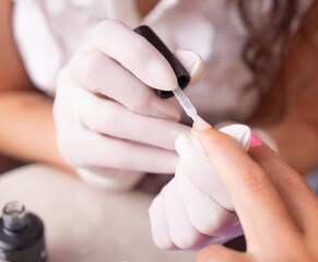 Obraz na płótnie Canvas woman applying nail polish.beauty salon