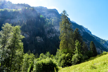 A magnificent crystal clear blue lake in the mountains. Swiss Alps. Summer mountain landscape. Blue water.