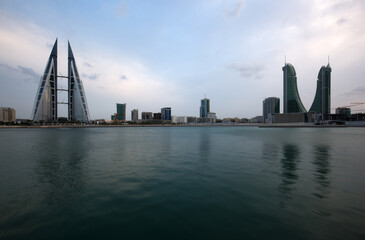 Naklejka premium MANAMA, BAHRAIN - OCTOBER 28: Bahrain skyline with iconic buildings, the Bahrain World Trade Center and the Financial Harbour during dusk on October 28, 2018, Manama, Bahrain