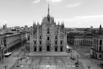 Italy, Milan July 2020 - Drone aerial view of Duomo Cathedral after finish of lockdown due COVID-19 Coronavirus outbreak, people outside with mask and tourist in downtown and Vittorio Emanuele Gallery