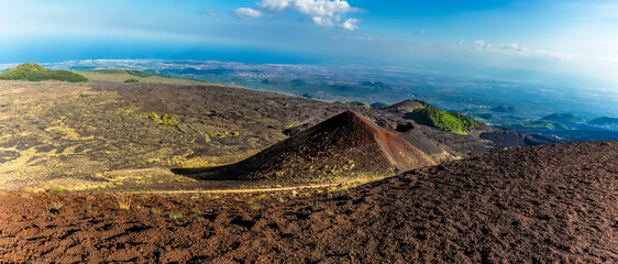 Panorama view of volcanic craters from the summit of  Mount Etna, Sicily looking towards the coast in summer © Nicola