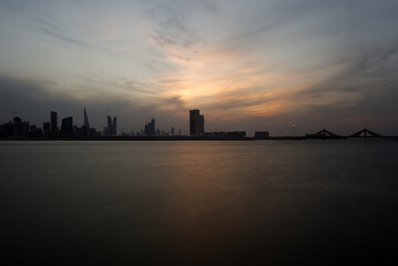 Fototapeta na wymiar Bahrain skyline at dusk with dramatic cloud