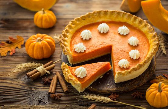 Fresh homemade pumpkin pie on the wooden table