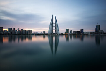 Naklejka premium MANAMA, BAHRAIN - NOVEMBER 02: The Bahrain World Trade Center during sunrise, a twin tower complex is the first skyscraper in the world to have wind turbines, November 02, 2018, Manama, Bahrain