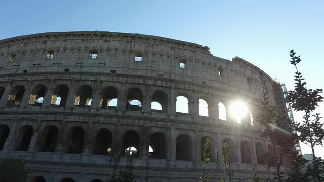 The outer surface of the Roman Colosseum Flour. Sunset. Cultural heritage of Italy.