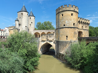 Fototapeta na wymiar Germans' Gate (Porte des Allemands) in Metz, France. This is the medieval fortified bridge across the Seille river with two round towers of the 13th century and two gun bastions of the 15th century.
