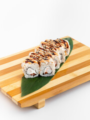 Maki Sushi Rolls set on wooden bamboo board. Japanese traditional Cuisine. White background.