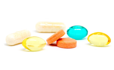 Colorful pills on white background. Bunch of different drugs and pills studio shot. Drug production industry.