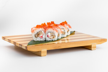 Maki Sushi Rolls set on wooden bamboo board. Japanese traditional Cuisine. White background.