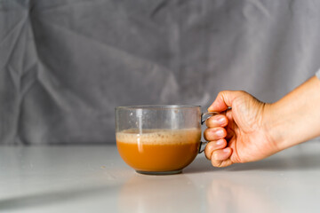 Holding a cup of black tea