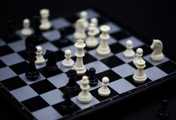 White king in chess game on chessboard. Black and white figure positioning. Chess figurine order. Checkmate game banner template. Intellectual sport. Strategic table game. Tactic decision concept