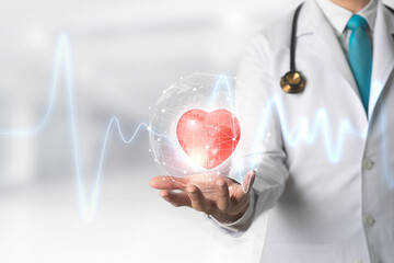 Medicine doctor holding red heart shape in hand with Technology Innovation and medicine concept.