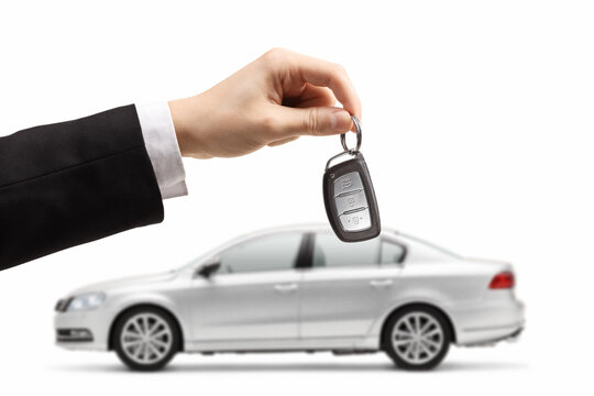 Male hand holding car keys from a silver car