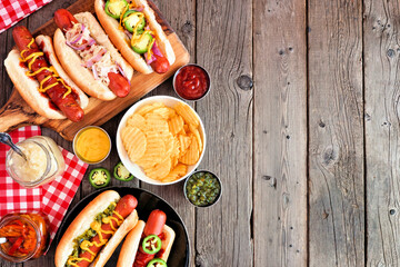 BBQ hot dog side border. Top down view table scene with a rustic wood background. Copy space.