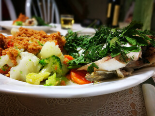 Polish traditional cuisine. Prepare tasty European seabass fish with dill and parsley leaves.
