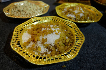 rock sugar and  dry grapes on a plate