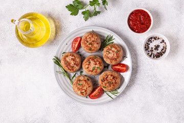 Fototapeta na wymiar Fresh chiken cutlets with tomatoes and rosemary