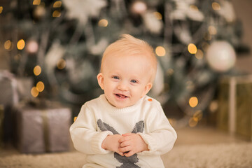 Cute toddler boy in posing at Christmas studio. Copy space.