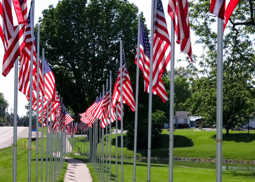 American Flags Lining Sidewalk In Small Town Park In Rural Illinois