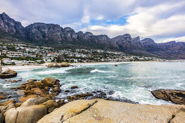 Fototapeta na wymiar Wonderful Camps Bay nature (Kampsbaai) before sunset - affluent suburb of Cape Town. Camps Bay bordered by spectacular Twelve Apostles Mountain and glittering Atlantic Ocean. Camps Bay, South Africa.