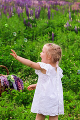 Cute little blonde girl play in nature