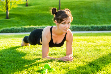 woman do yoga in the park and smiles. summer, sun, health. outdoor sports. healthy sport lifestyle....