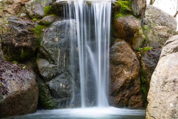 Fototapeta na wymiar A little waterfall in a park