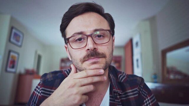 Young man looking to camera and listening