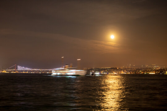 Bosphorus view at night with a full moon during lunar eclipse