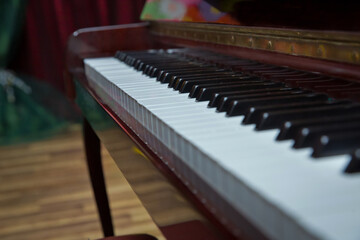 piano presses . Piano keys close up. Musical instrument . Select focus and soft focus.Close-up of a wooden piano . Defocused classic piano keyboard in white and brown colors .