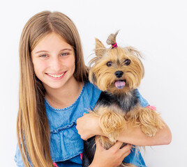 Portrait of cute girl holding terrier dog