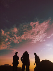 silhouettes of people on sunset