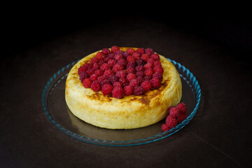 Slice of curd cake with raspberries