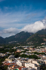 Fototapeta na wymiar Landscape view of the mountais and part of Rio de Janeiro city integrated with a cloudy and sunny blue sky