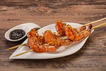 Grilled prawn skewer with pepper sauce