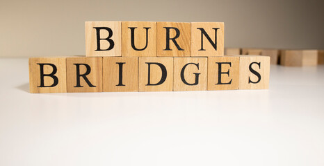 Fighting means leaving, burn bridges. Made of wooden cubes on white background.