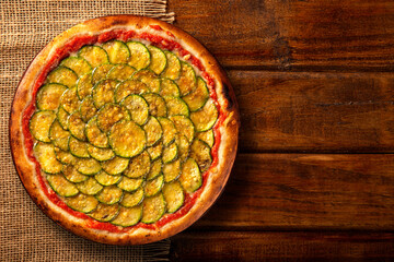Brazilian pizza with zucchini and cheesel. Top view on wood background, close up. Traditional Brazilian Pizza