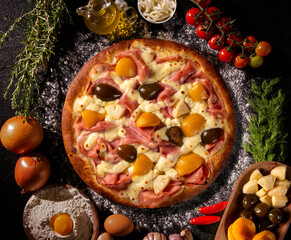 Sweet pizza with peaches, fig and pineapple on black concrete background. Top view, close up. Traditional Brazilian Pizza