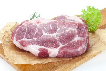 Raw pork steak over wooden board