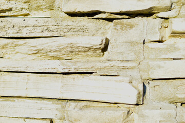 Construction masonry of rough yellow stones in the form of Sandstone