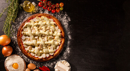palm heart and cream cheese Pizza. Top view on black concrete background, close up. Traditional Brazilian Pizza