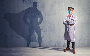 Brave Doctors with his shadow of superhero on the wall. Concept of powerful man © chaiyapruek