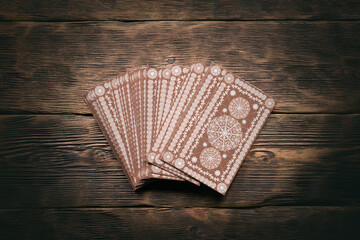 Tarot cards on the wooden table background.