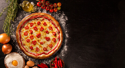 Red pepper and cheese Pizza. Top view on black concrete background, close up. Traditional Brazilian Pizza