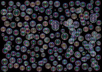 Rainbow soap bubbles on a dack background. Abstract background 