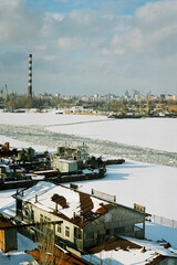 Fototapeta na wymiar Industrial port. Spring ice drift. Big river in the city.